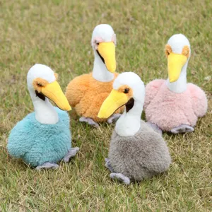 Cute pelican plush toys detail shot showcasing colorful stuffed bird dolls on natural grass.