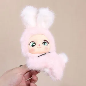 Detailed close-up of a cute pink plush bunny doll pendant with vinyl face and big green eyes.