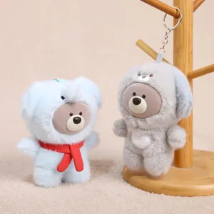Close-up detail of cute vinyl face plush animal keychain pendant hanging on wooden stand display.