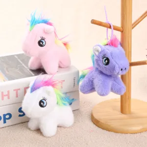 Detail view of cute colorful plush unicorn pony hanging pendant with vibrant rainbow mane.