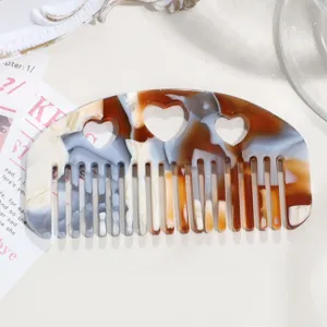 Acetate hair comb with heart hollow cutout and vintage tortoiseshell pattern for women hair styling.