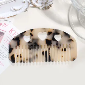 Tortoise shell acetate hair comb detail, retro hollow heart design for bangs styling.