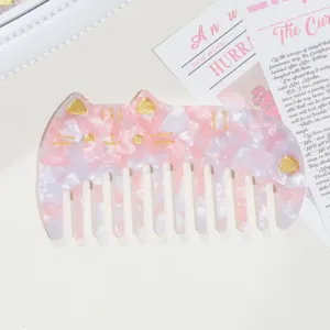 Pink marbled cat shaped acetate hair comb with gold details and smooth teeth for daily styling.