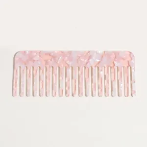 Pink tortoise acetate wide tooth hair comb detail view, anti-static detangling hair tool.