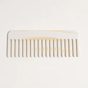 Close-up of wide tooth acetate hair comb, tortoiseshell gradient design for smooth styling.