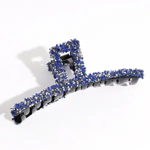 Large rhinestone hair claw clip for women, sparkling blue crystal shark clip for thick hair styling.