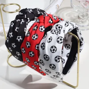 Closeup of stylish fabric headbands with soccer ball print, knotted design in three colors.