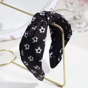 Black soccer print wide knotted fabric headband, stylish sports hair accessory for women.