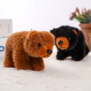 Close-up detail shot of cute brown and black plush bear toys on fluffy white background.
