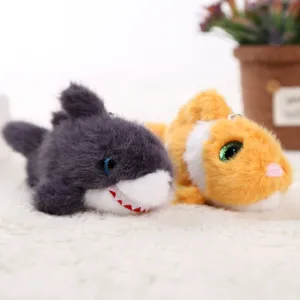 Close-up of cute plush marine animal keychains featuring soft shark and fish doll designs.