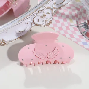 Pink acetate hair claw clip featuring 3d angel wings and delicate rhinestones detail.