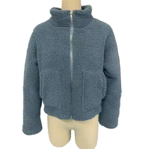 Detail view of the grey-blue fleece zip jacket, featuring cozy texture and stand collar.