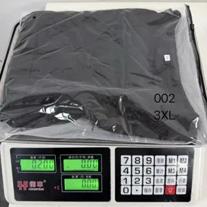 Black babywearing t-shirt detail showing 3xl size packaging and product weight on digital scale.