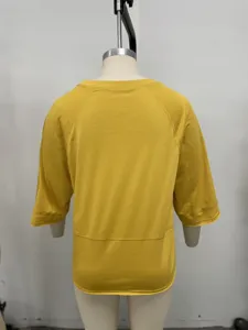 Back detail of solid yellow half sleeve casual women t-shirt with raglan cut and round neck.