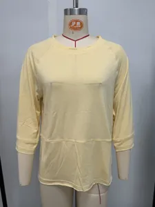 Detail view of casual light yellow raglan 3/4 sleeve t-shirt, soft fabric and loose fit.