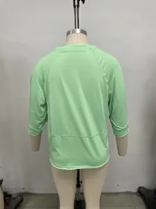 Back view detail of casual light green round neck mid sleeve t-shirt showing fine stitching.