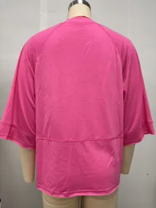 Back view detail of women's loose solid pink three-quarter flare sleeve t-shirt casual top.