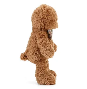 Ours en peluche marron avec nœud papillon à carreaux classique, détail de poils longs.