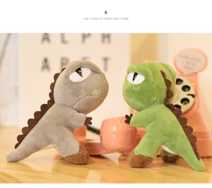 Close up detail of mini standing dinosaur plush toy, cute green and grey cute dolls.