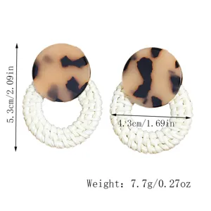 Detail view of fashion rattan woven earrings with tortoiseshell resin studs, lightweight.