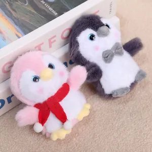 Cute plush penguin doll pendant with scarf and bow, soft stuffed toy for backpack bag charm.