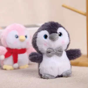Cute grey penguin plush toy detail, soft stuffed animal doll with bow tie, adorable gift.