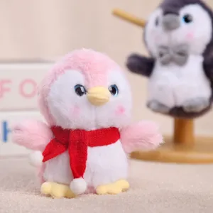 Cute pink penguin plush toy pendant with red scarf, soft stuffed doll bag charm accessory.