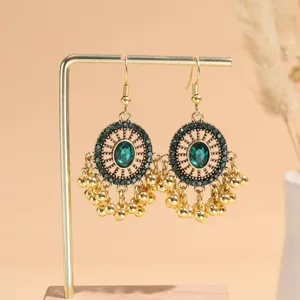 Vintage gold-toned green crystal wheel dangle earrings with delicate bead fringe for women.