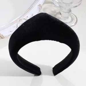Detailed view of the black velvet padded headband, showing the soft fabric texture.