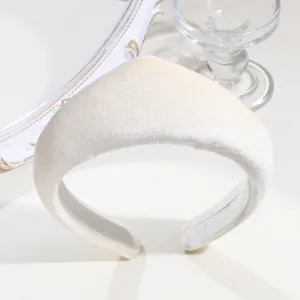 Detail shot of retro white velvet padded crown headband, elegant court style hair accessory.
