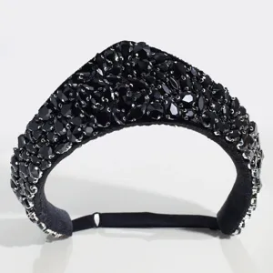 Detail view of a retro court-style black crystal rhinestone crown headband accessory.