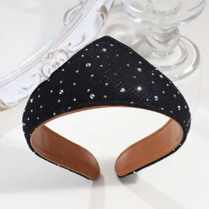Close-up detail of black rhinestone headband with brown leather lining, elegant court style.