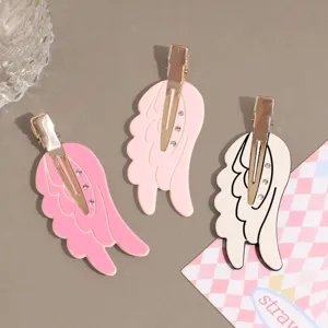 Angel wing hair clips detail view, cute rhinestone side clips for sweet daily hair styling.