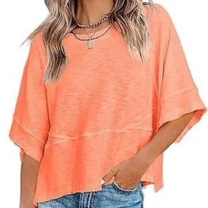 Close-up detail of the casual loose bell-sleeve top showing neck and sleeve design.