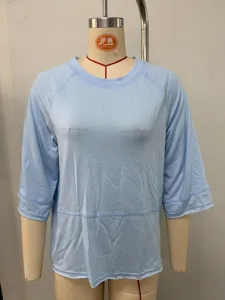 Light blue casual womens t-shirt detail view, classic round neck and raglan sleeves.