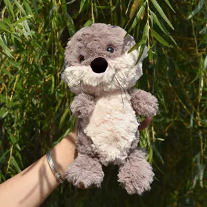 Close up of cute plush otter toy, soft fluffy fabric, detailed facial features, outdoor view.