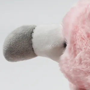 Close-up detail of the cute pink flamingo plush toy, soft fabric texture and vivid design.