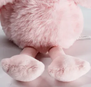 Close-up detail of fluffy pink plush toy showing soft stuffed doll texture and cute feet.