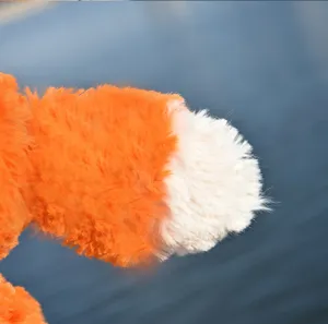 Cute fox plush toy detail shot, soft stuffed animal fluffy orange and white design.