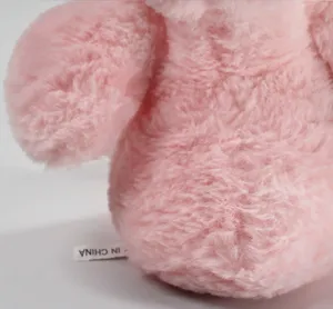 Cute pink plush toy detail view, soft fluffy stuffed animal doll for girls birthday gift.