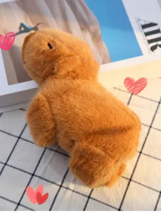 Detailed close-up shot of the cute brown capybara plush toy showing soft texture and cozy setting.