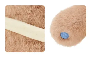 Plush toy detail closeup featuring soft brown fur texture and cute embroidered blue accent element.