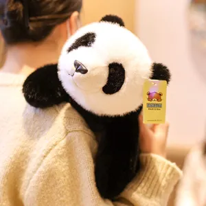 Detail shot of cute panda plush toy resting on shoulder, soft stuffed animal companion.