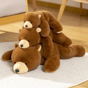 Cute brown bear plush toy, soft stuffed animal lying flat hugging pillow for kids and home decor.