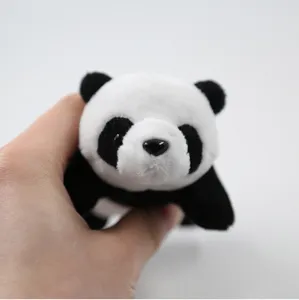 Close-up detail of cute black and white plush panda pendant showing soft fabric texture.