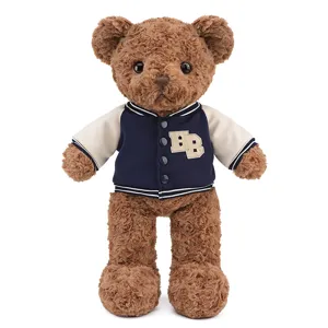 Ours en peluche marron jouet avec veste universitaire bleue variante, poupée.