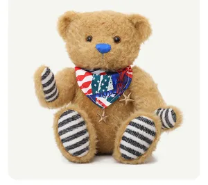 Muro orsetto di peluche marrone articolato con naso blu e sciarpa con stella decorata.