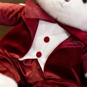 Close-up of plush toy in red velvet suit and white vest with buttons, soft texture detail.