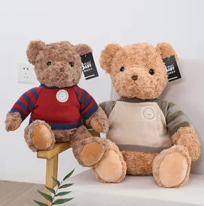 Detailed view of cute plush teddy bear toy wearing retro sweater, soft stuffed doll gift.