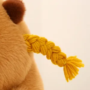 Close-up view of cute capybara plush toy showcasing soft brown fur texture and braided tail.